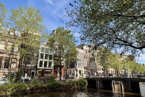 Historic Amsterdam canal houses and bridge on a sunny day, one day in Amsterdam