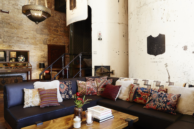 Cozy seating inside Sternwirth at Hotel Emma. Behind the sofas is the brew tank.