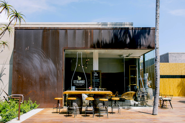 Strange Family vineyards tasting room exterior with tables outside.
