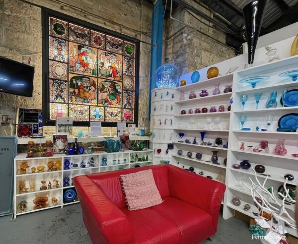 hand blown glassware in multiple colors inside the Bath Aqua Glass studio, Bath, England.