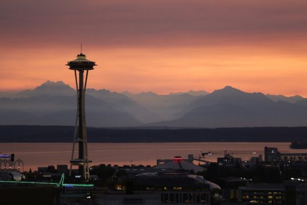 Space needle and mountains from top things to do in Seattle for first time visitors