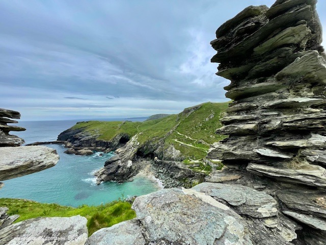 Tintagel cove view through an opening in the castle wall. Tintagel, Cornwall, UK.