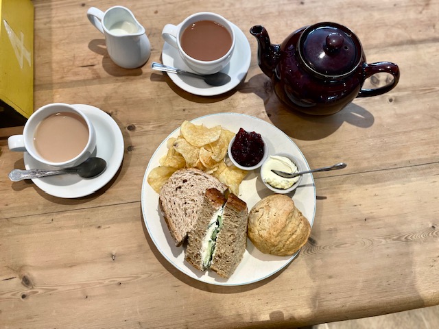 Tea pot and sandwich with tea cups