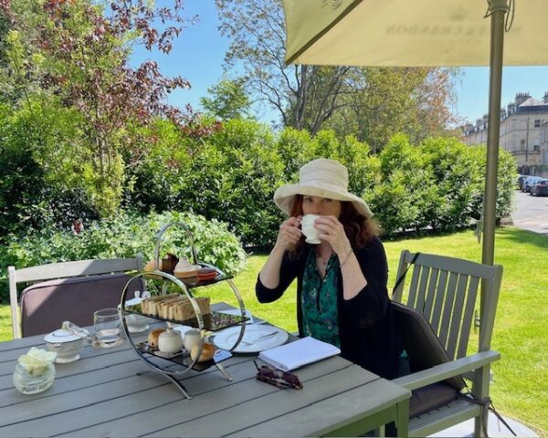 woman drinking tea outside Roseate Villa Bath