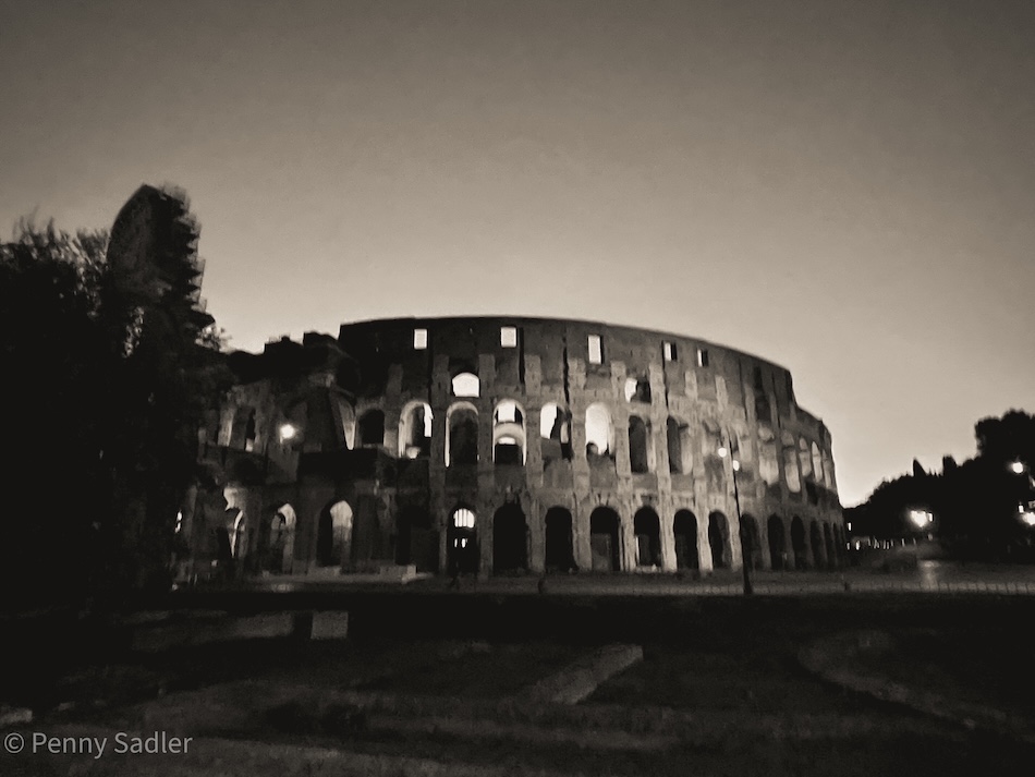 the Roman Colosseum at dusk.