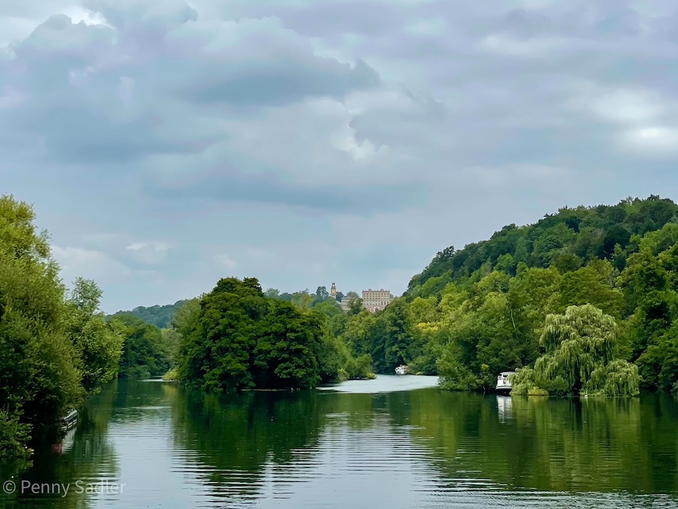 Cliveden Reach on River Thames with historic house visible on hillside.