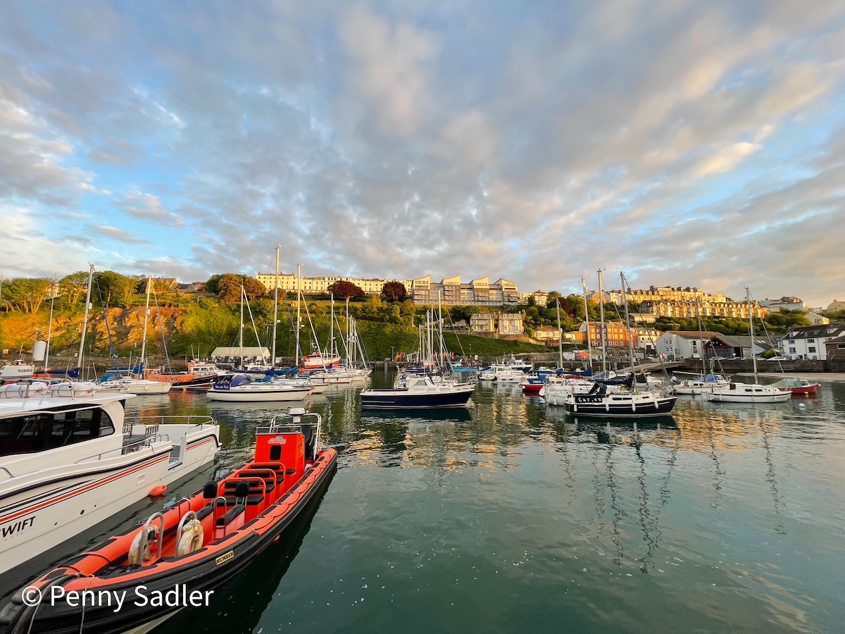boats in the Ilfracombe harbor and color victorian architecture on the hillside North Devon